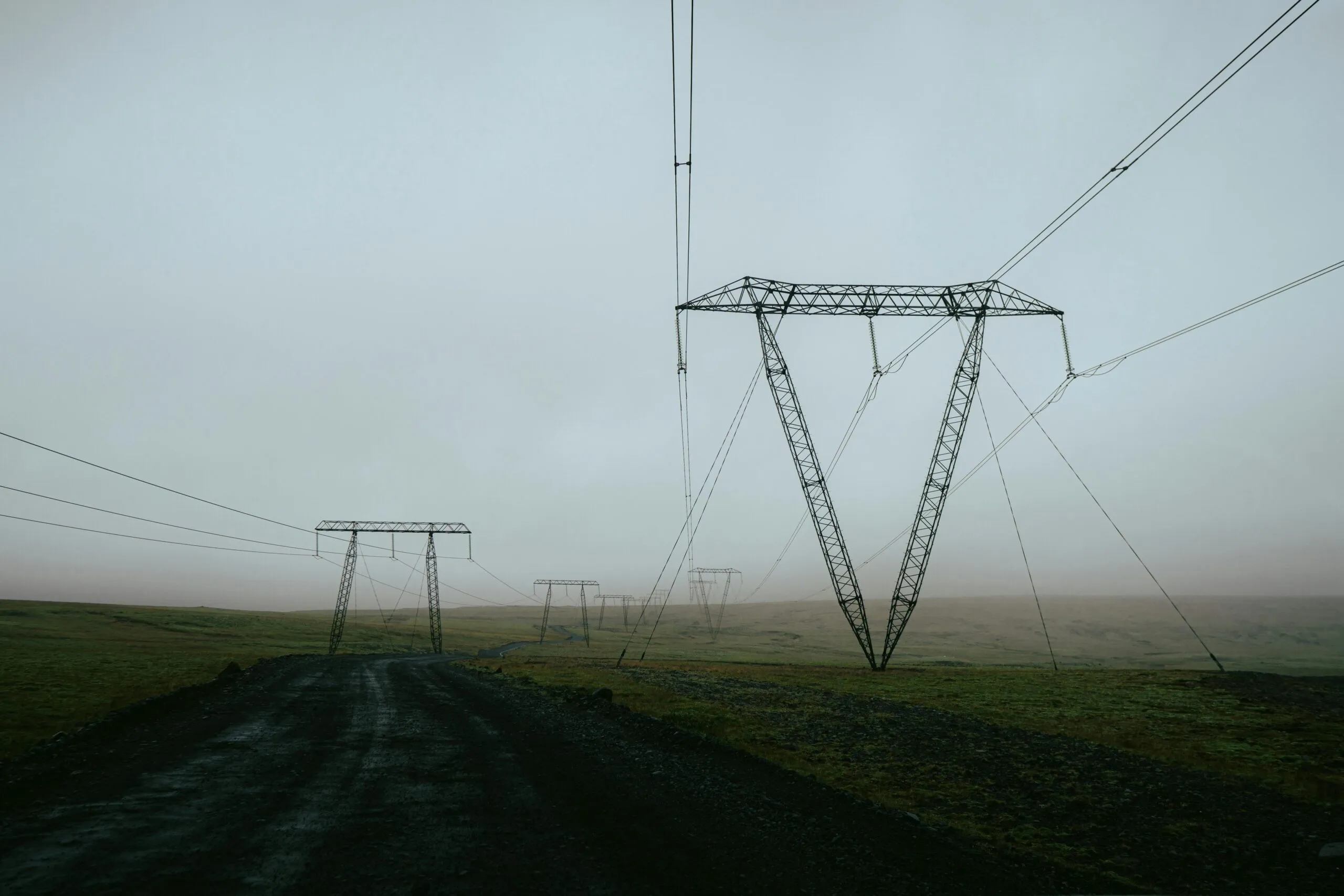 Power lines stretch across a misty landscape in Skeiða- og Gnúpverjahreppur, Iceland.
