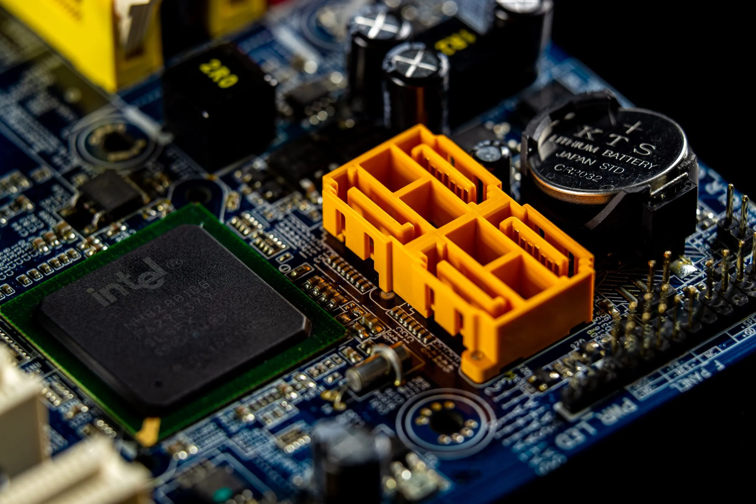 Detailed view of a computer motherboard showcasing an Intel microprocessor and electronic components.